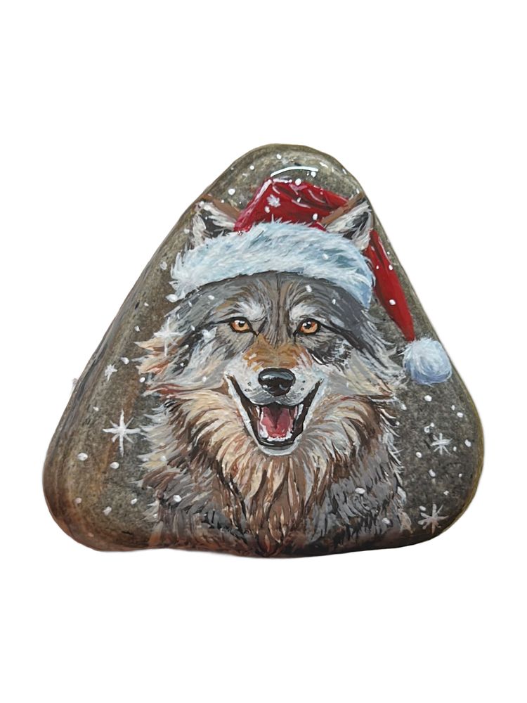 Wolf with Santa hat painted on a stone